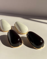 Oversized glossy black teardrop statement stud earrings with gold-tone trim from Lysaire