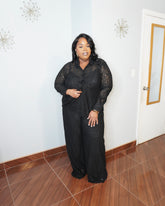 Plus size model wearing black lace pant set with button-down top and wide-leg pants front view elegant outfit