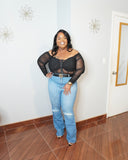 Plus size jeans styled with black mesh corset top for a night out look