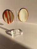 Soléa Luxe oversized oval statement earring in blush pink with cream stripes and polished gold-tone setting displayed on mannequin