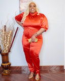 Side angle of plus size red satin pant set showing stretch fit and front slit detail