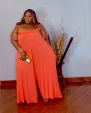 Plus size orange oversized wide leg jumpsuit with stretch fabric side view from Lysaire boutique