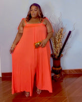Plus size orange oversized wide leg jumpsuit with stretch fabric front view from Lysaire boutique