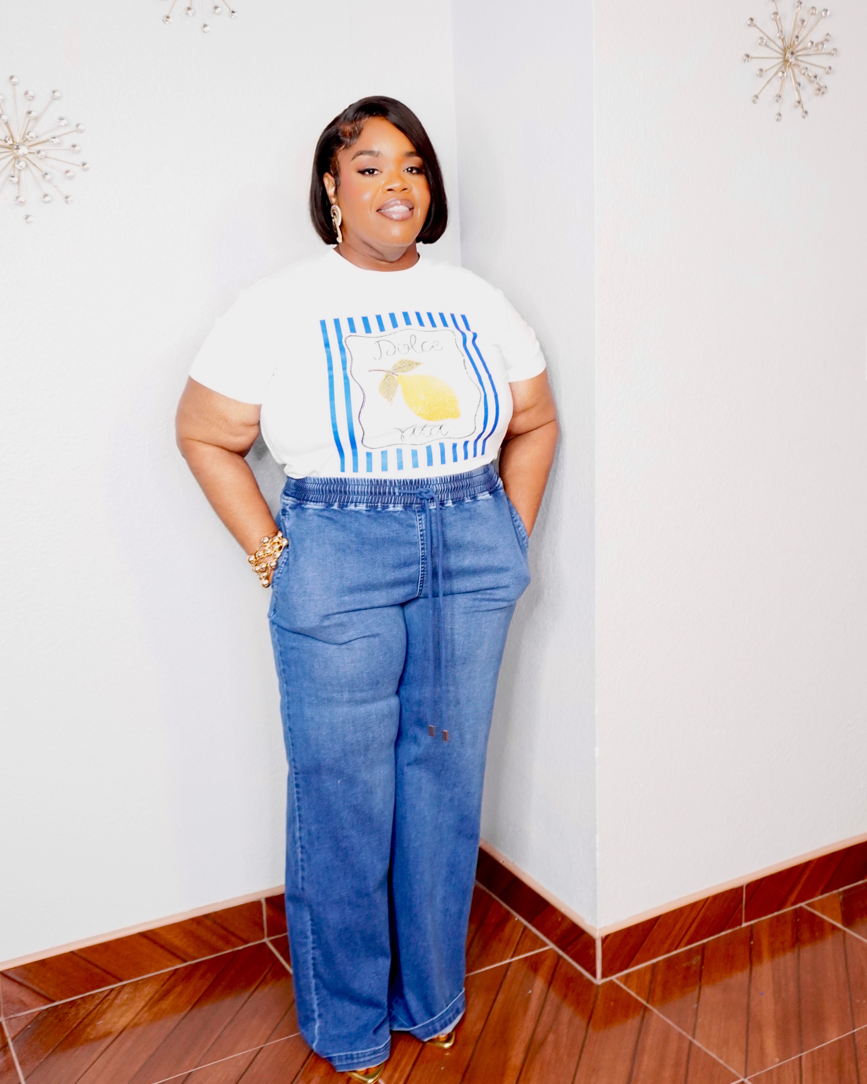 Plus size woman wearing soft stretch denim drawstring wide leg pants with elastic waist and pockets