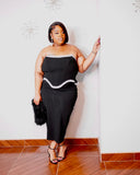 Black strapless plus-size cocktail dress with silver embellished corset-style waist and fitted midi skirt.