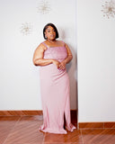 Angled front view of the LYSAIRE Rosé Royale dusty pink plus size formal gown, featuring a fitted embellished bodice with shimmering pink rhinestones and pearl-inspired accents, elegant square neckline, delicate shoulder straps, and a flowing floor-length skirt designed for sophisticated special occasions.