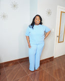 Smiling model wearing plus size ribbed knit pant set with wide leg silhouette