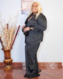Side view of plus size black pant set with statement 3D flower detail and elegant silhouette