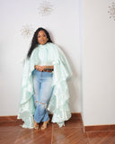 Plus size woman wearing mint two-piece cascading statement top with high-low layered design