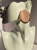 Pair of oversized ivory cream oval statement earrings with subtle striped detailing and polished gold-tone frames