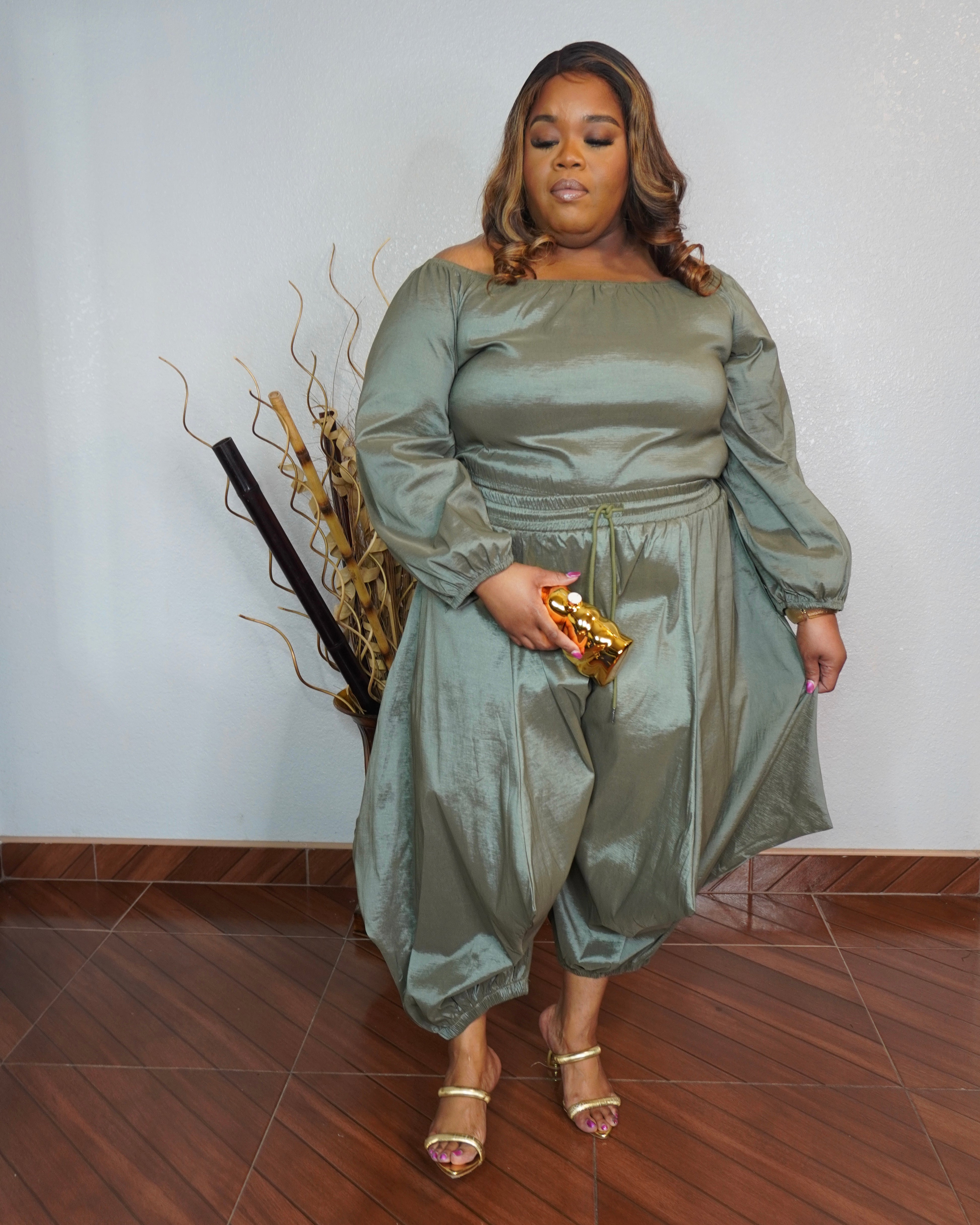 Front view of plus size olive two piece pant set with off shoulder top and flowy fit