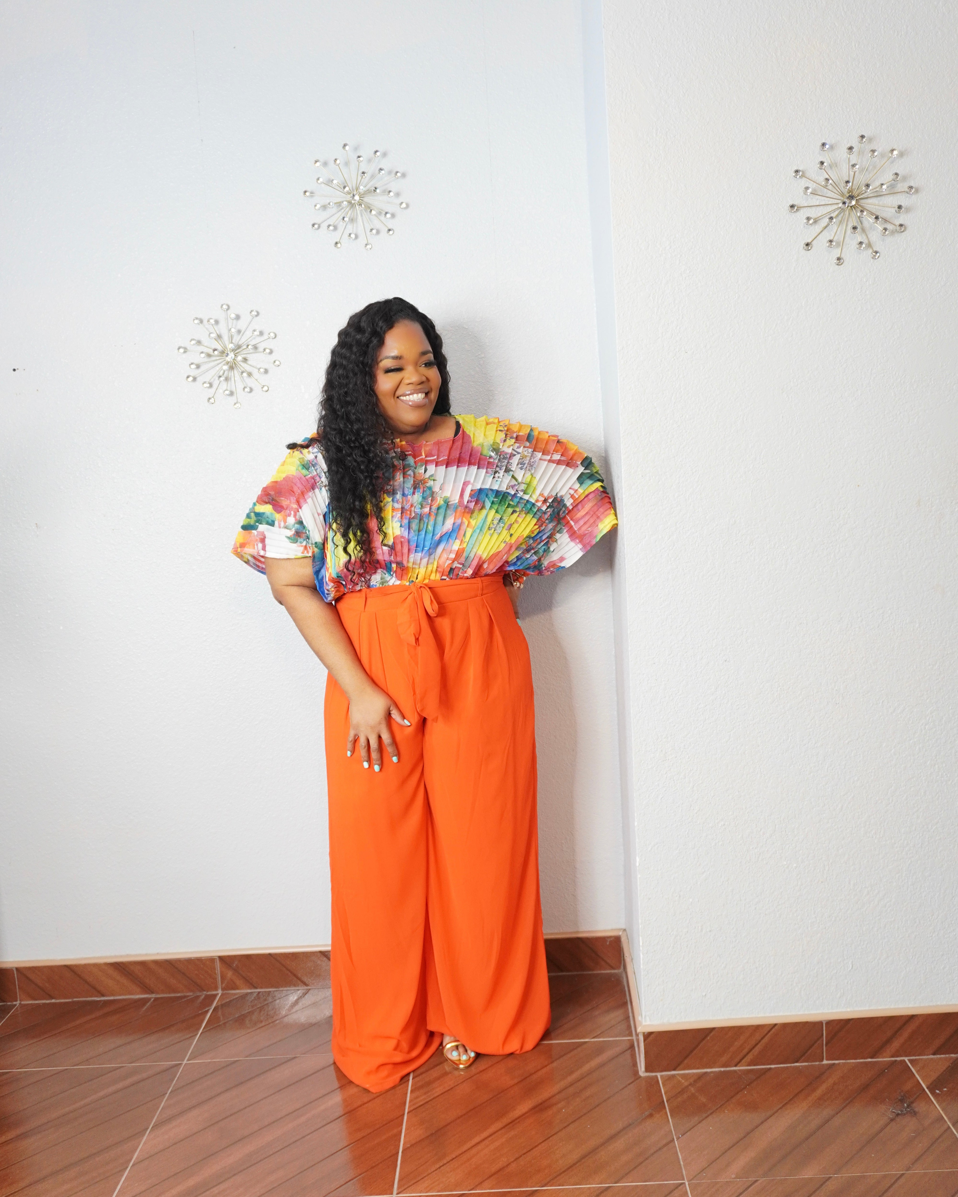 Curvy woman wearing extra-long orange wide-leg pants