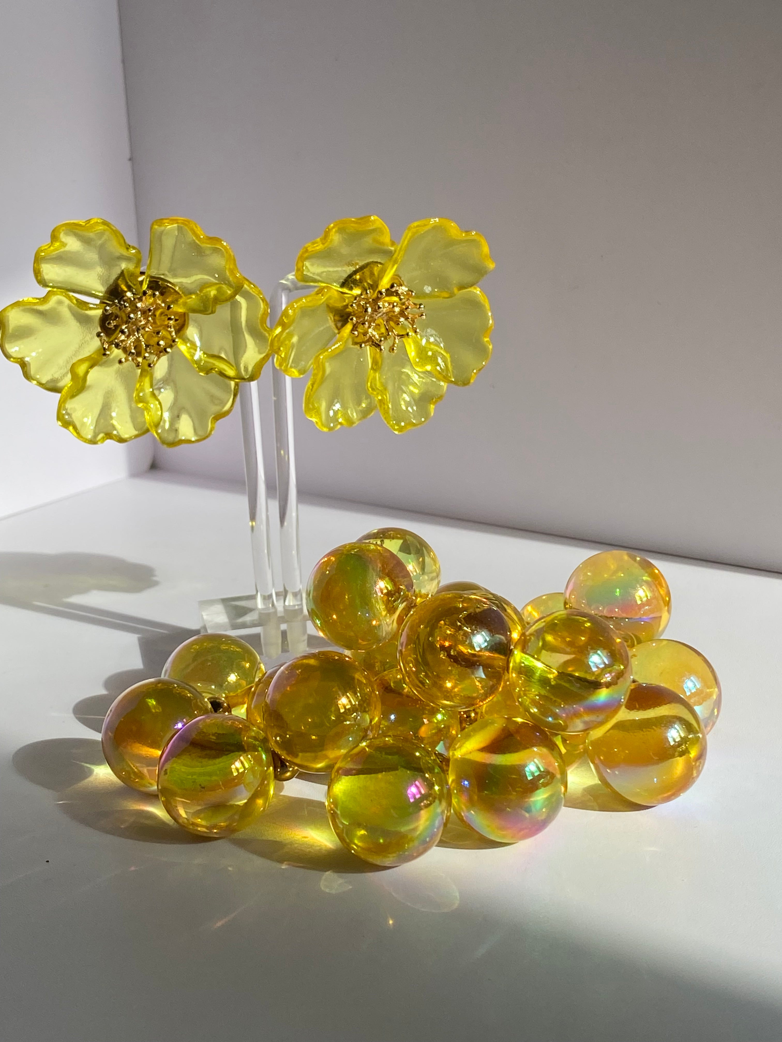 Oversized yellow flower statement earrings with translucent petals and sculptural gold-tone centers
