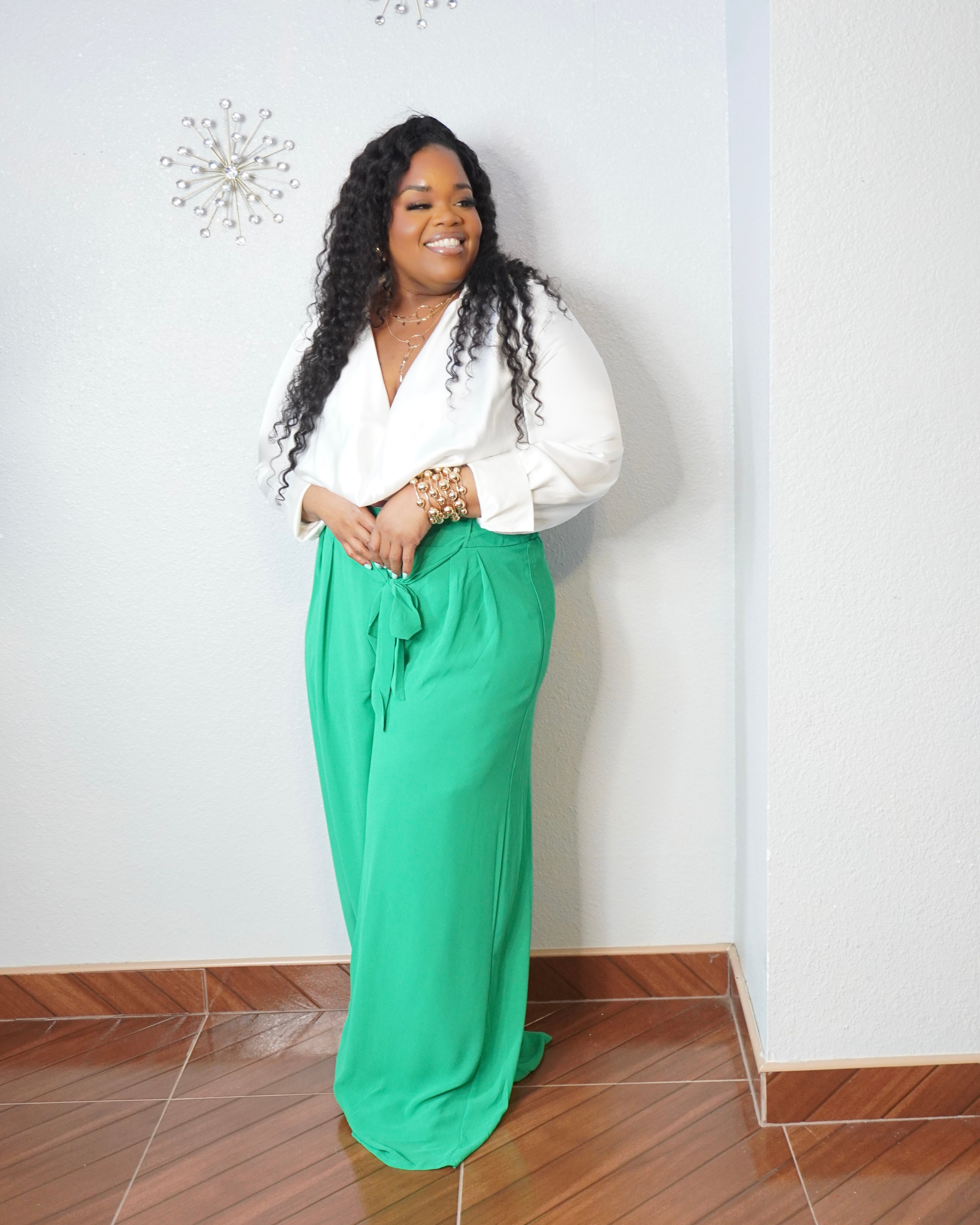 Curvy woman wearing green tall-girl-friendly wide-leg trousers