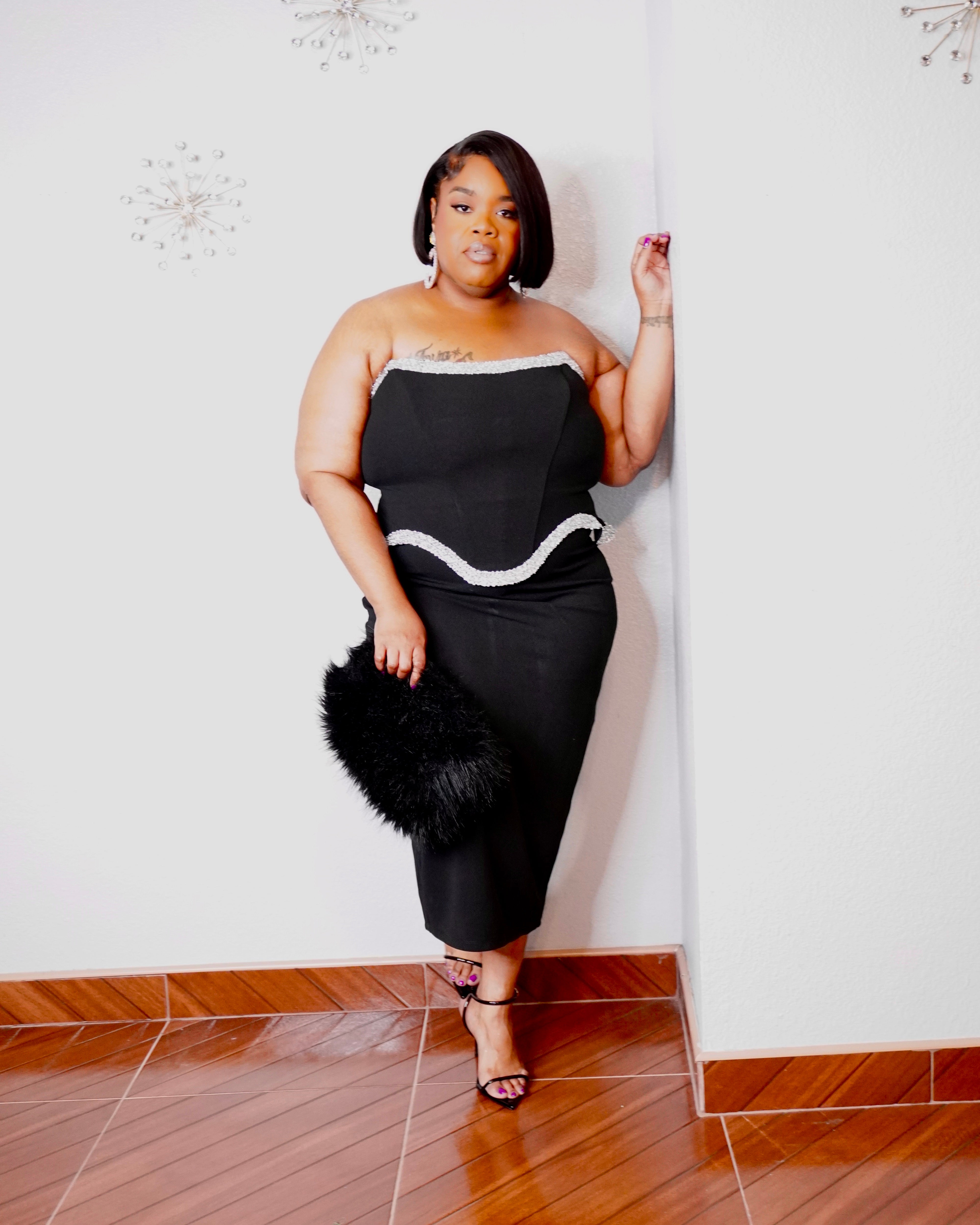 Plus-size black formal midi dress featuring a structured bodice and sparkling silver-tone detailing.