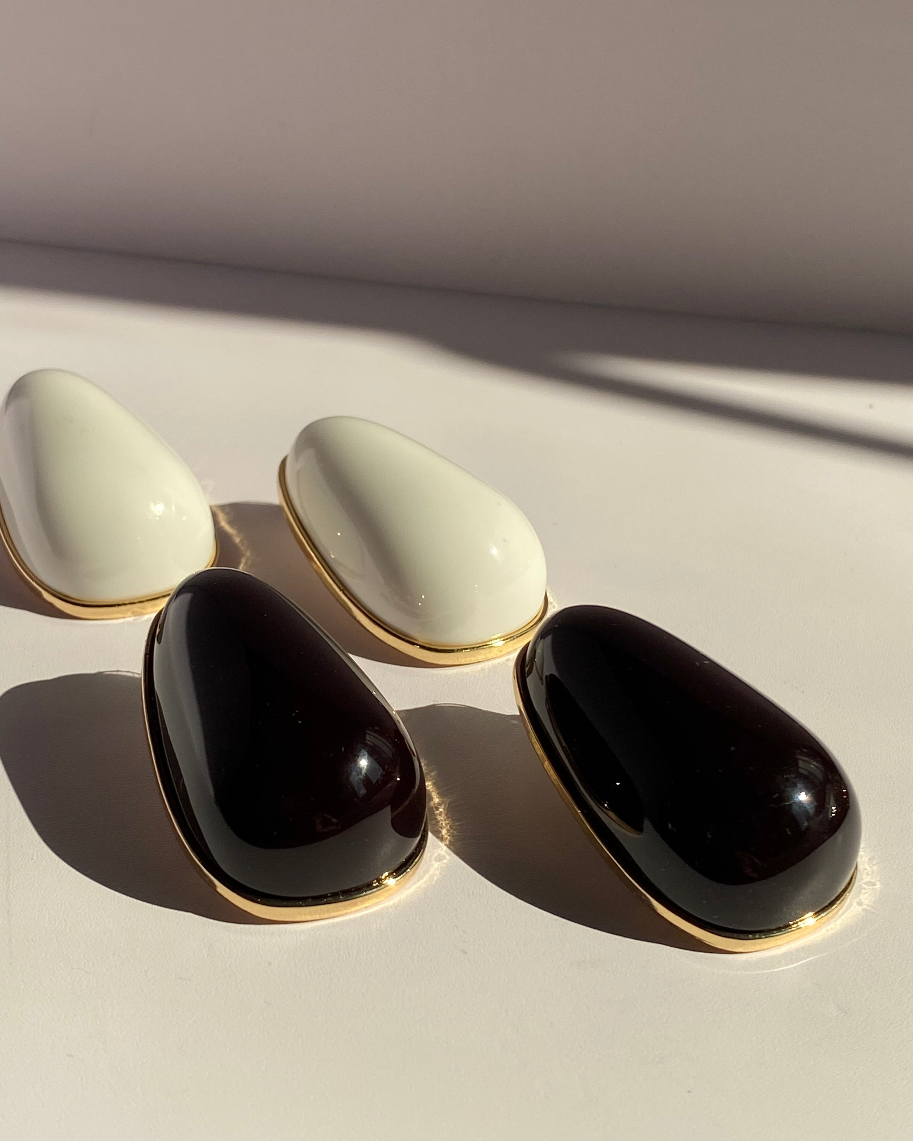 Oversized glossy black teardrop statement stud earrings with gold-tone trim from Lysaire