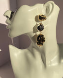 Gold and silver mixed metal abstract drop statement earring displayed on jewelry bust