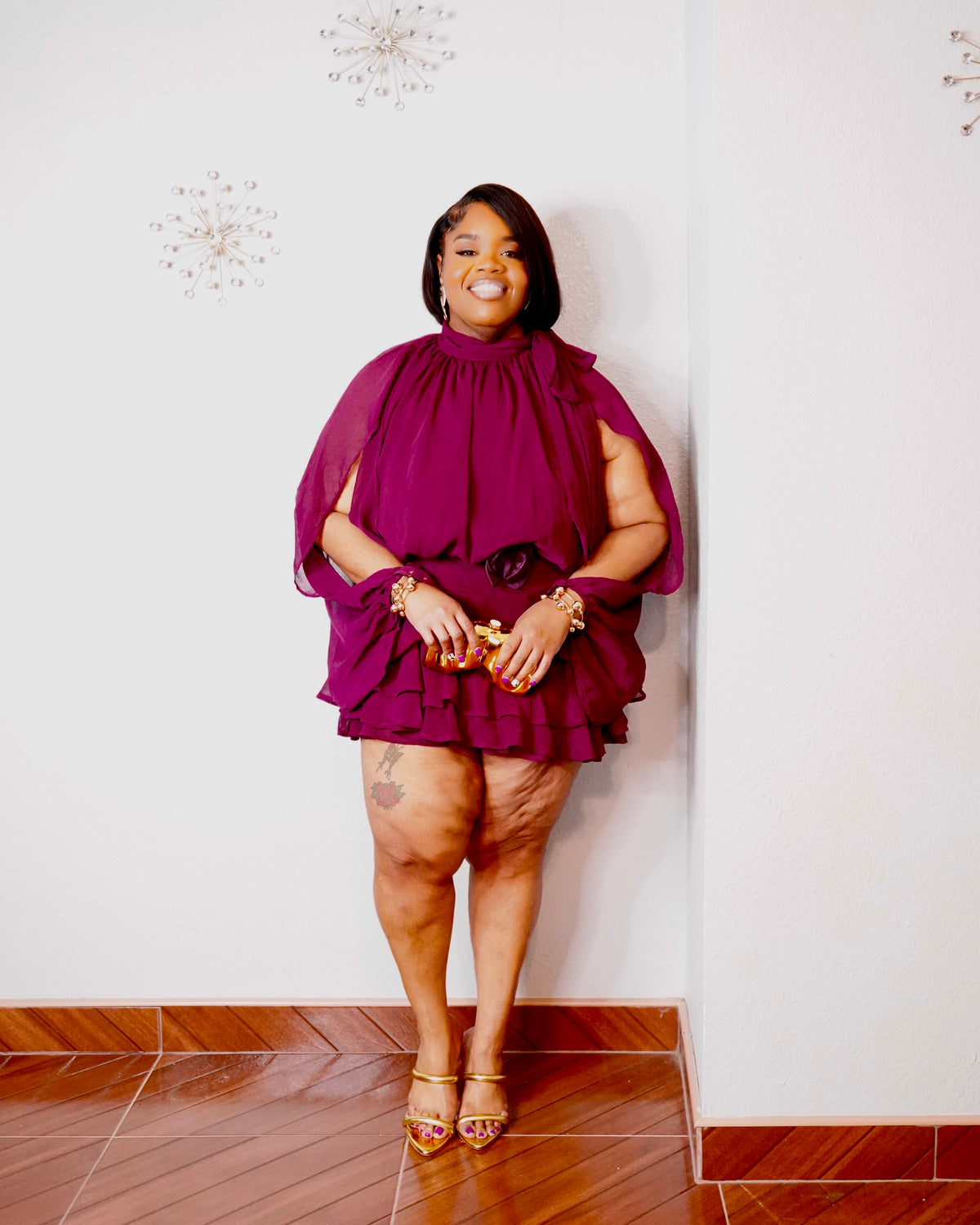Royal plum ruffle romper with cape sleeves