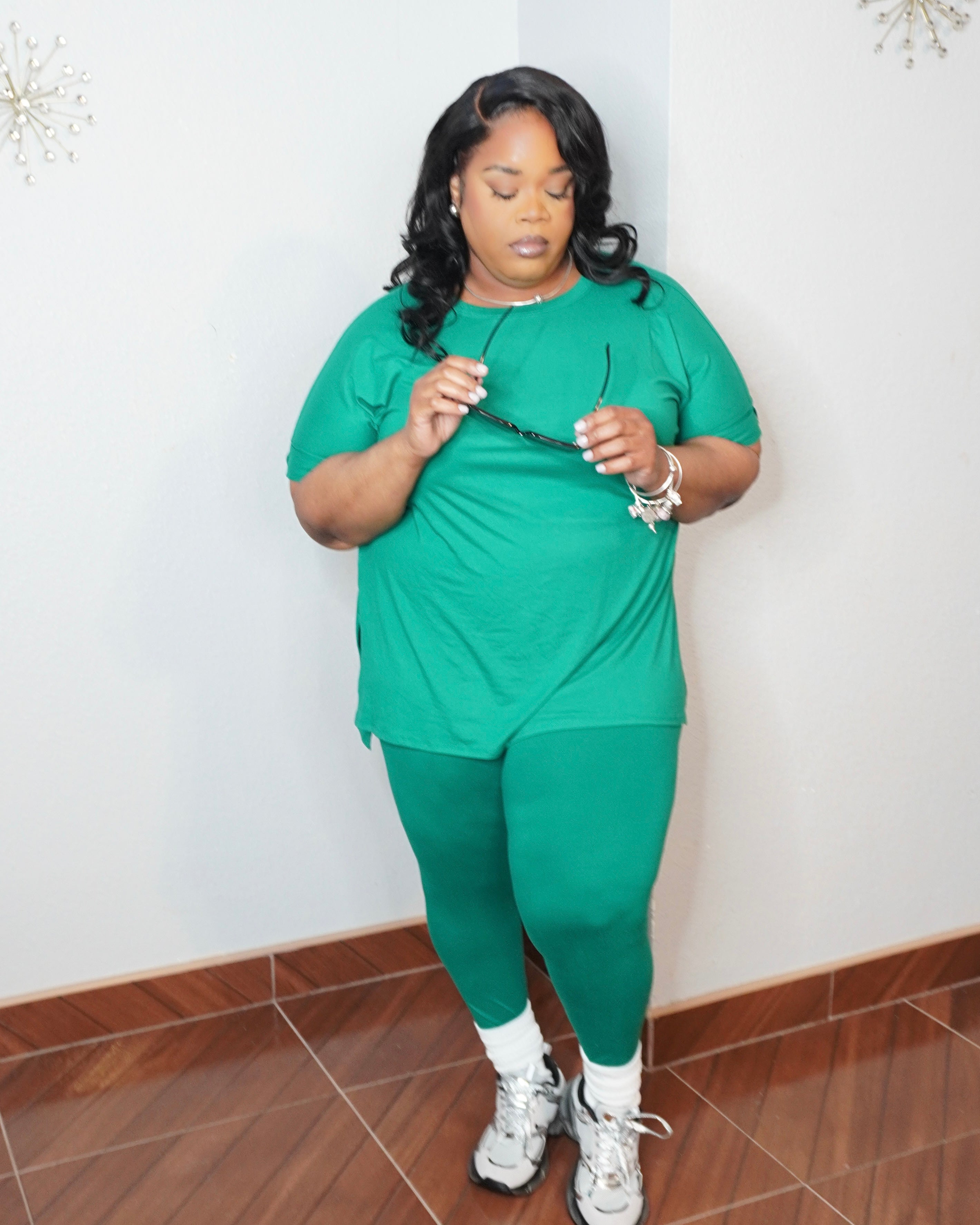 Side angle of plus size green legging set styled with sneakers casual look