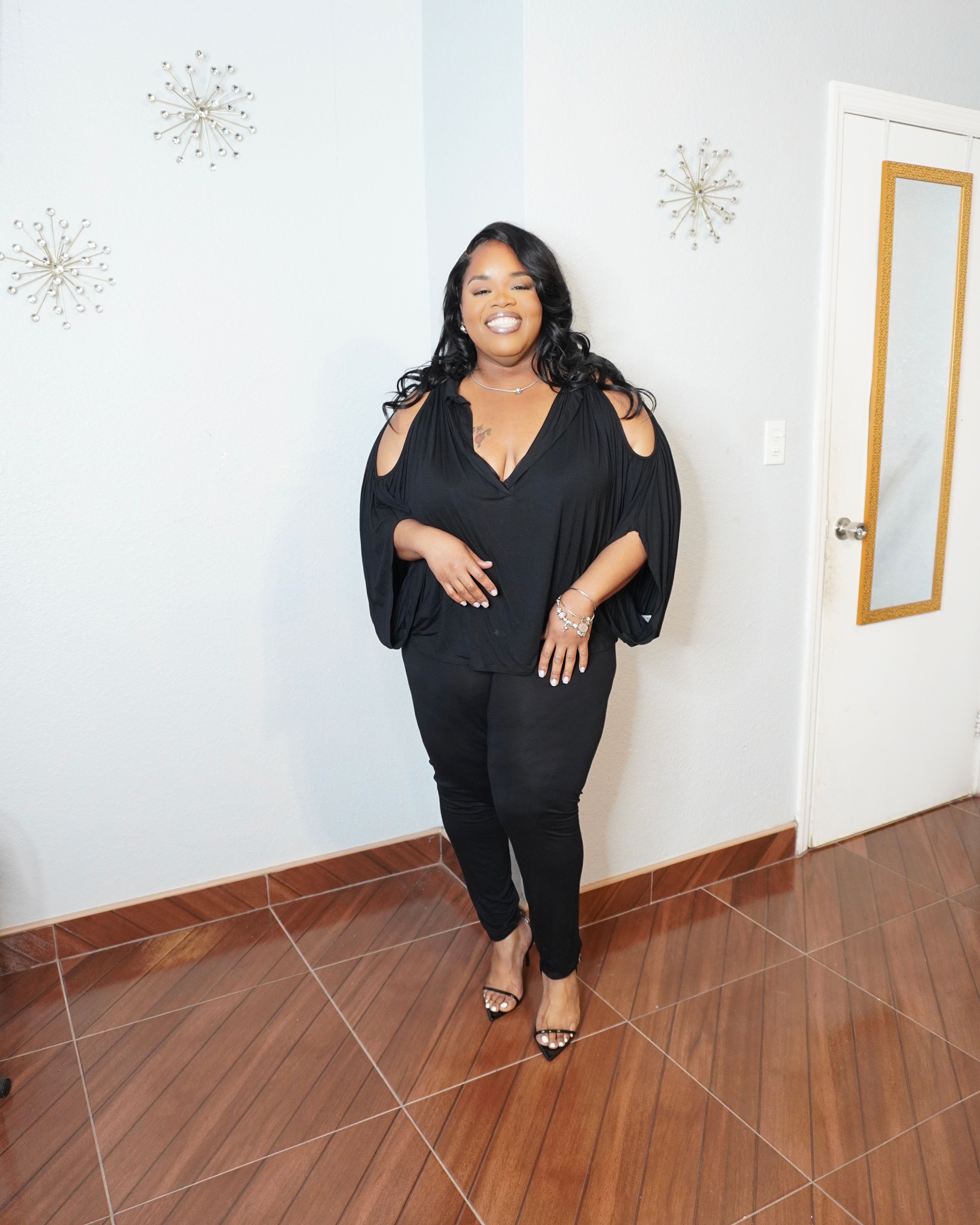 Front view of plus size flowy top and fitted leggings two piece set