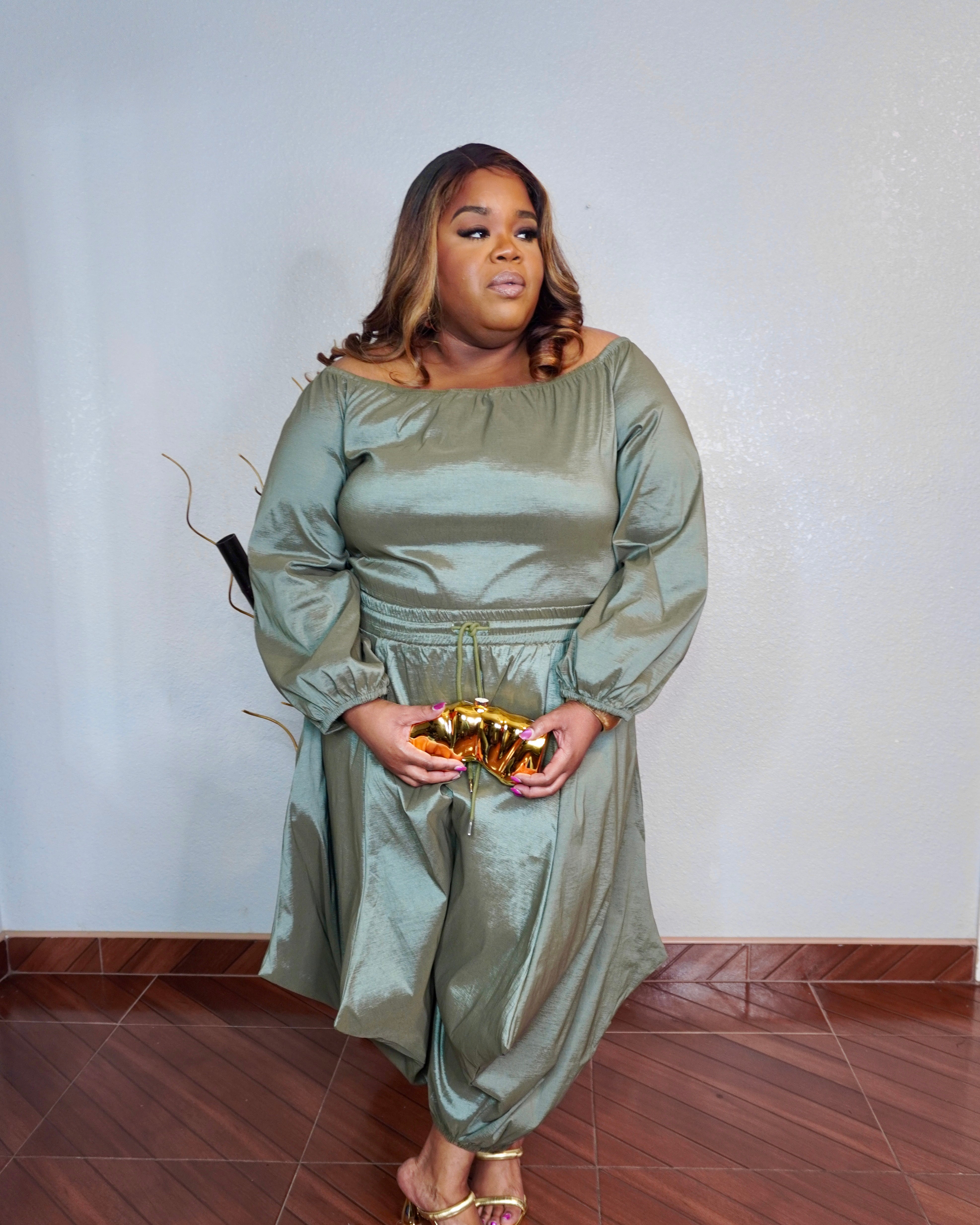 Front view of plus size olive two piece pant set with off shoulder top and flowy fit