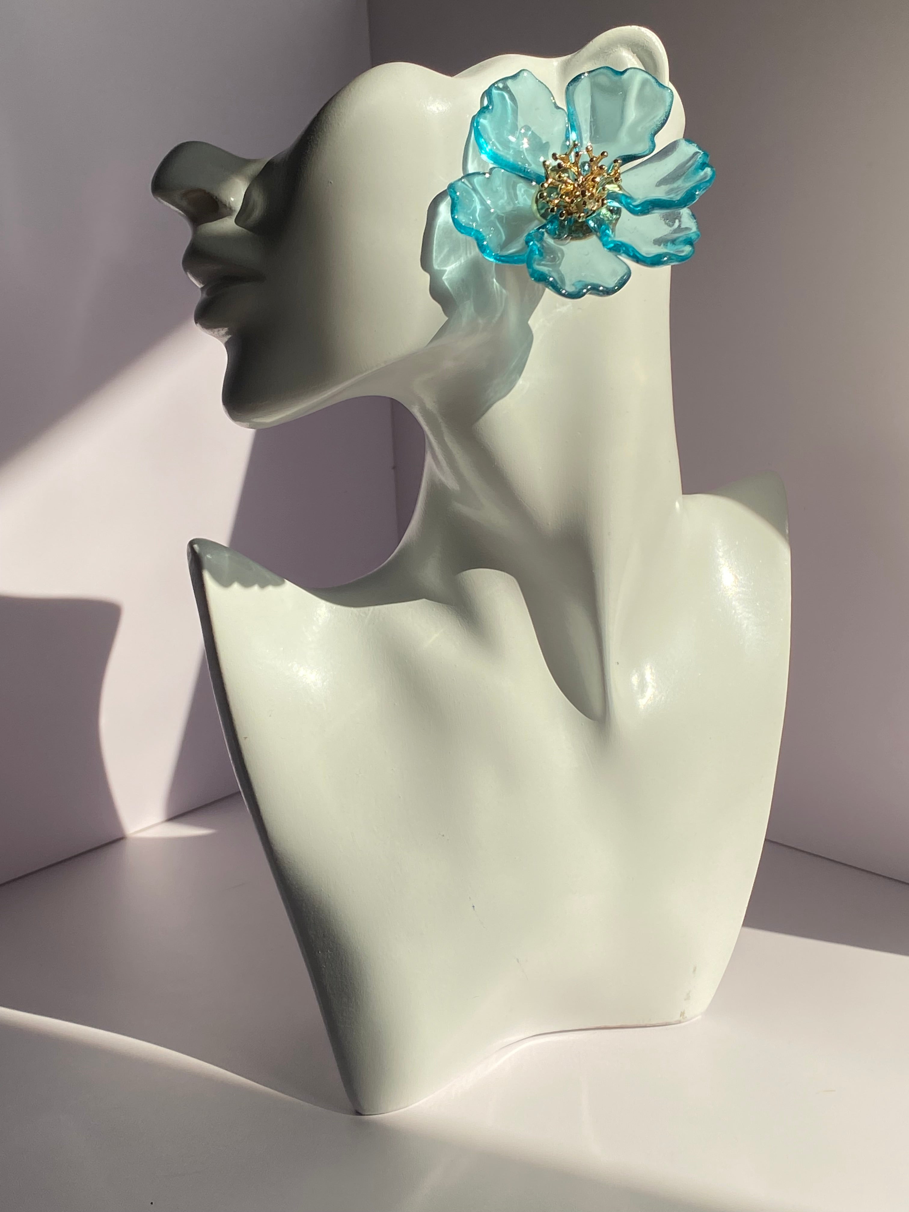 Aqua blue oversized flower earring featuring translucent turquoise-edged petals and gold-tone centerpiece