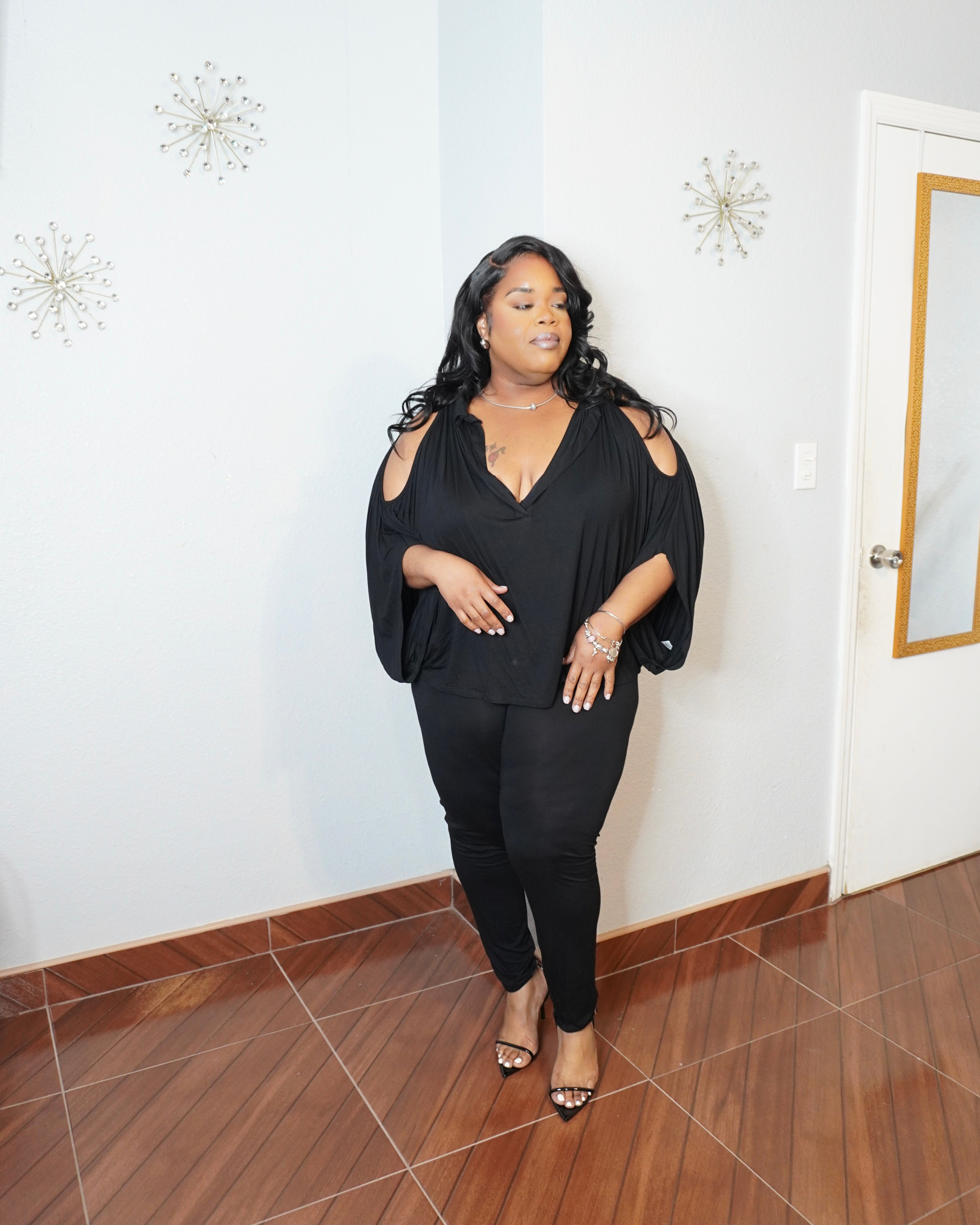Side angle of plus size batwing top showing draped silhouette
