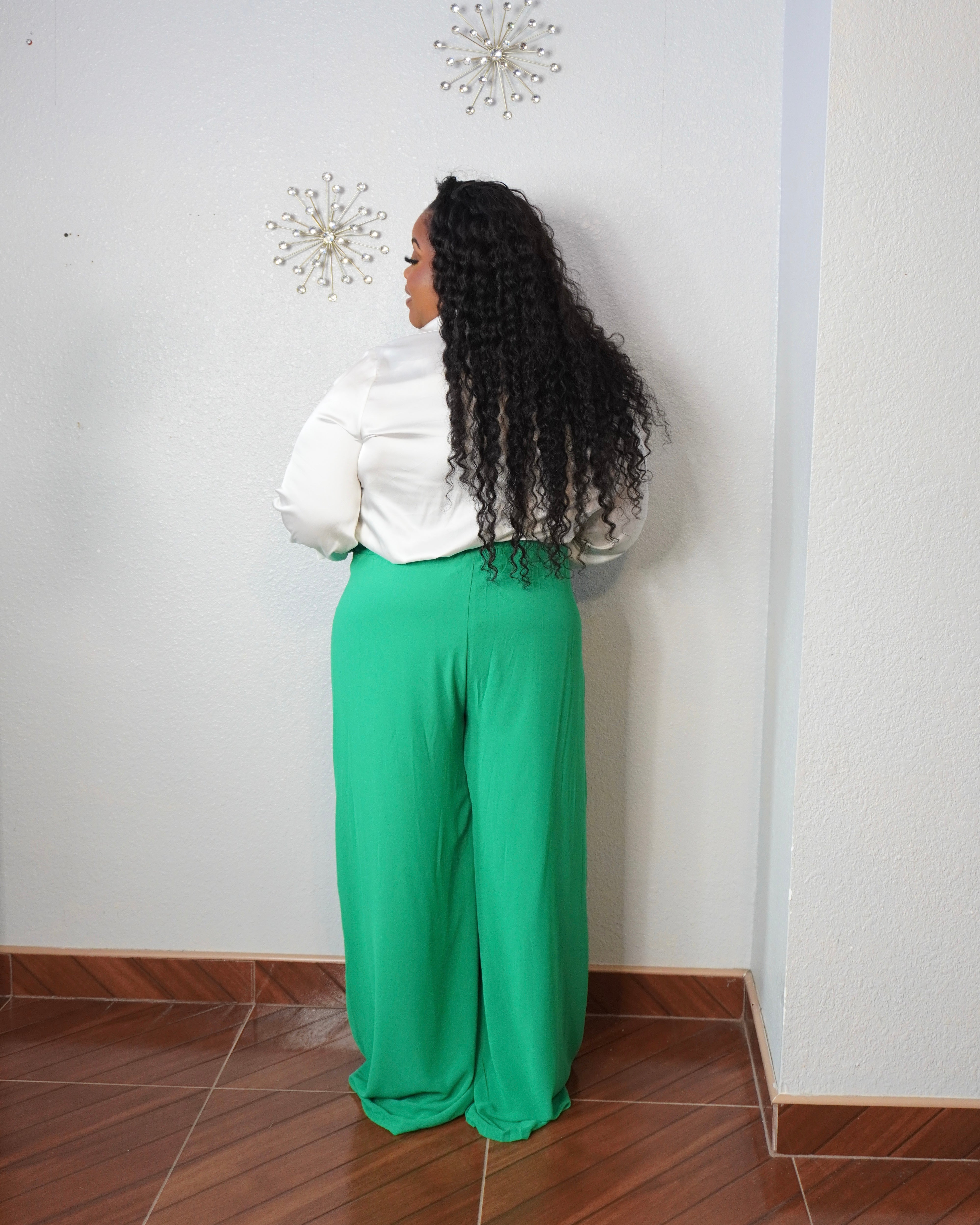 Curvy woman wearing green tall-girl-friendly wide-leg trousers