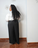 Back view of plus size black pleated wide-leg pants