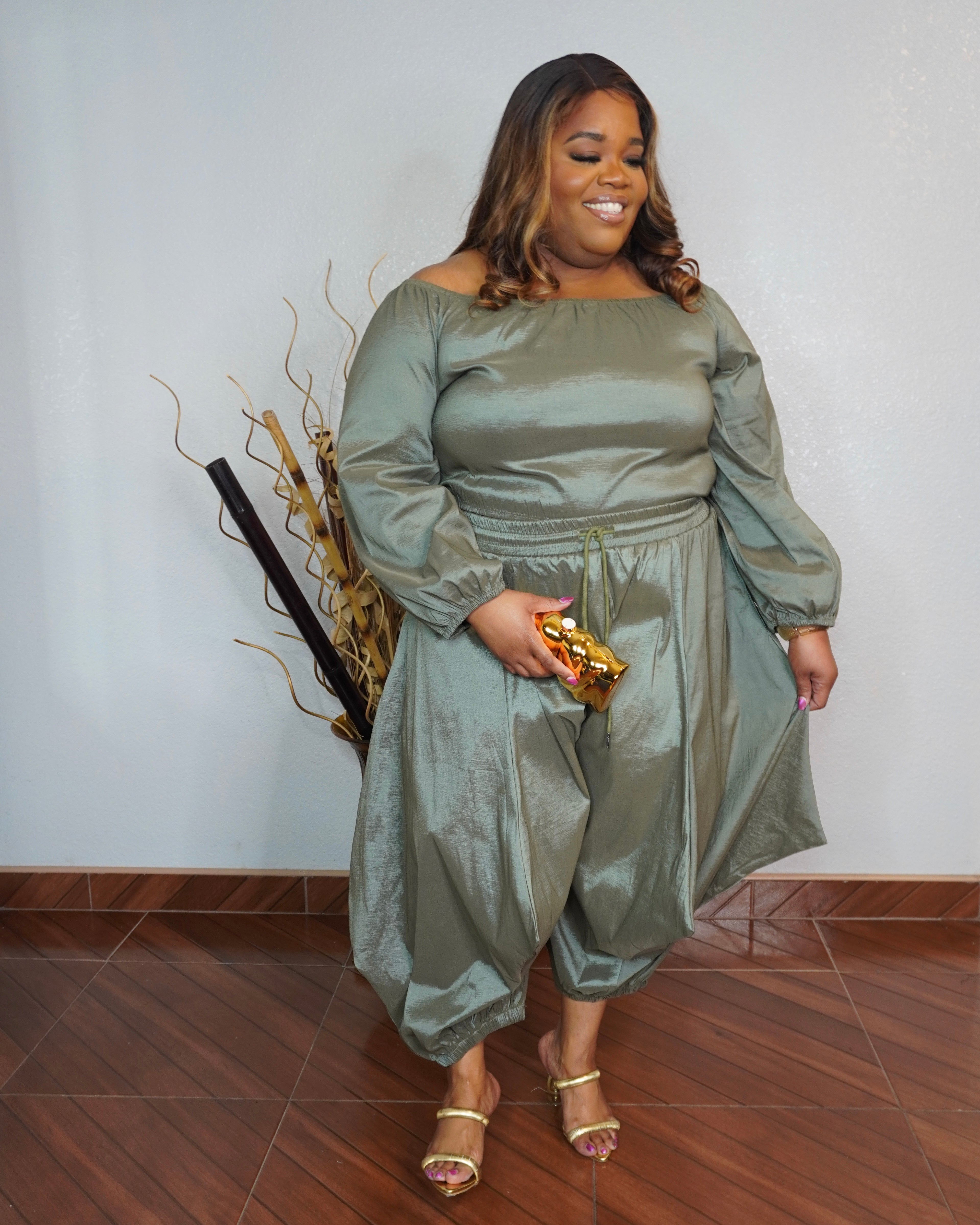 Front view of plus size olive two piece pant set with off shoulder top and flowy fit