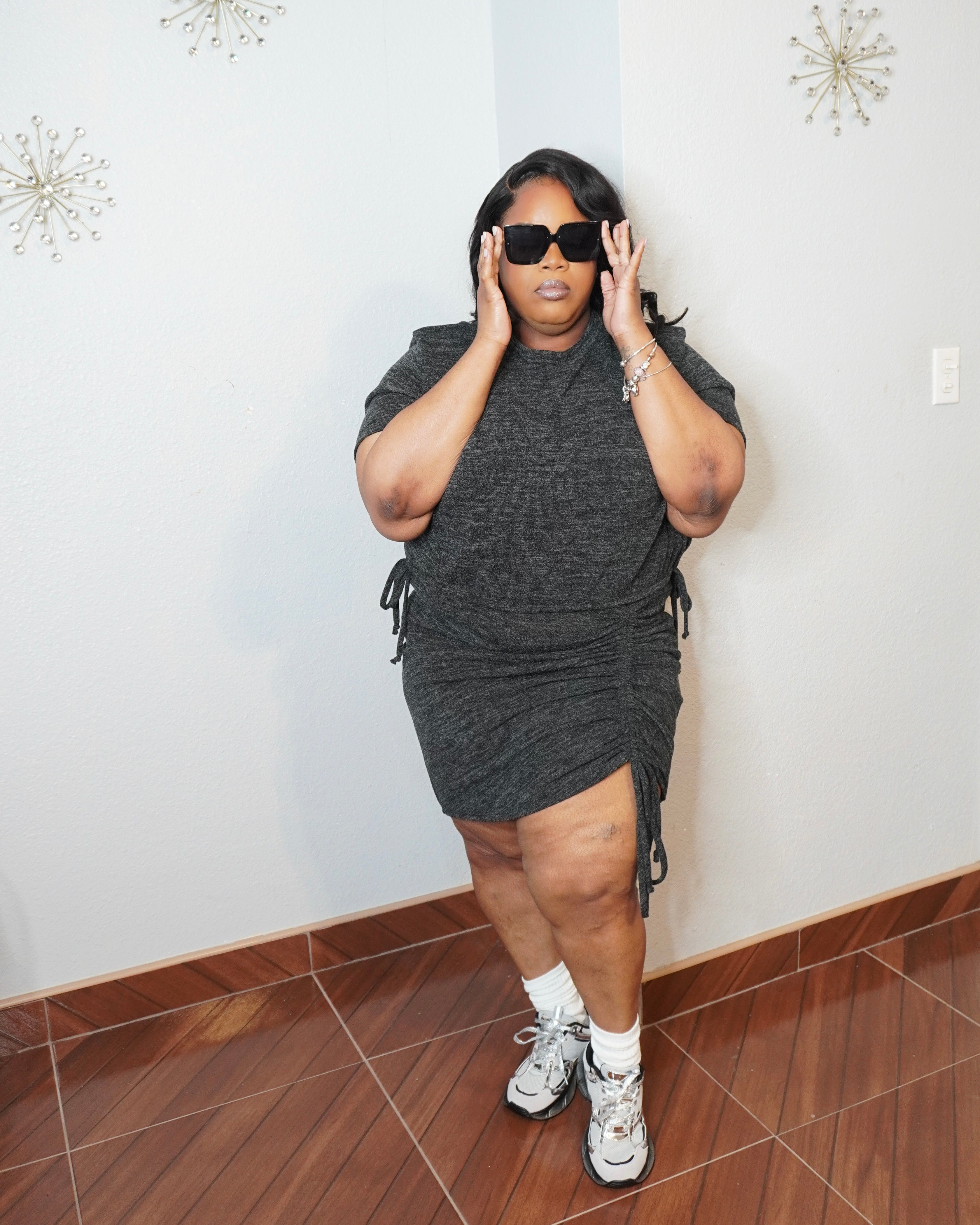 Model wearing plus size ruched skirt set adjusting sunglasses full body view
