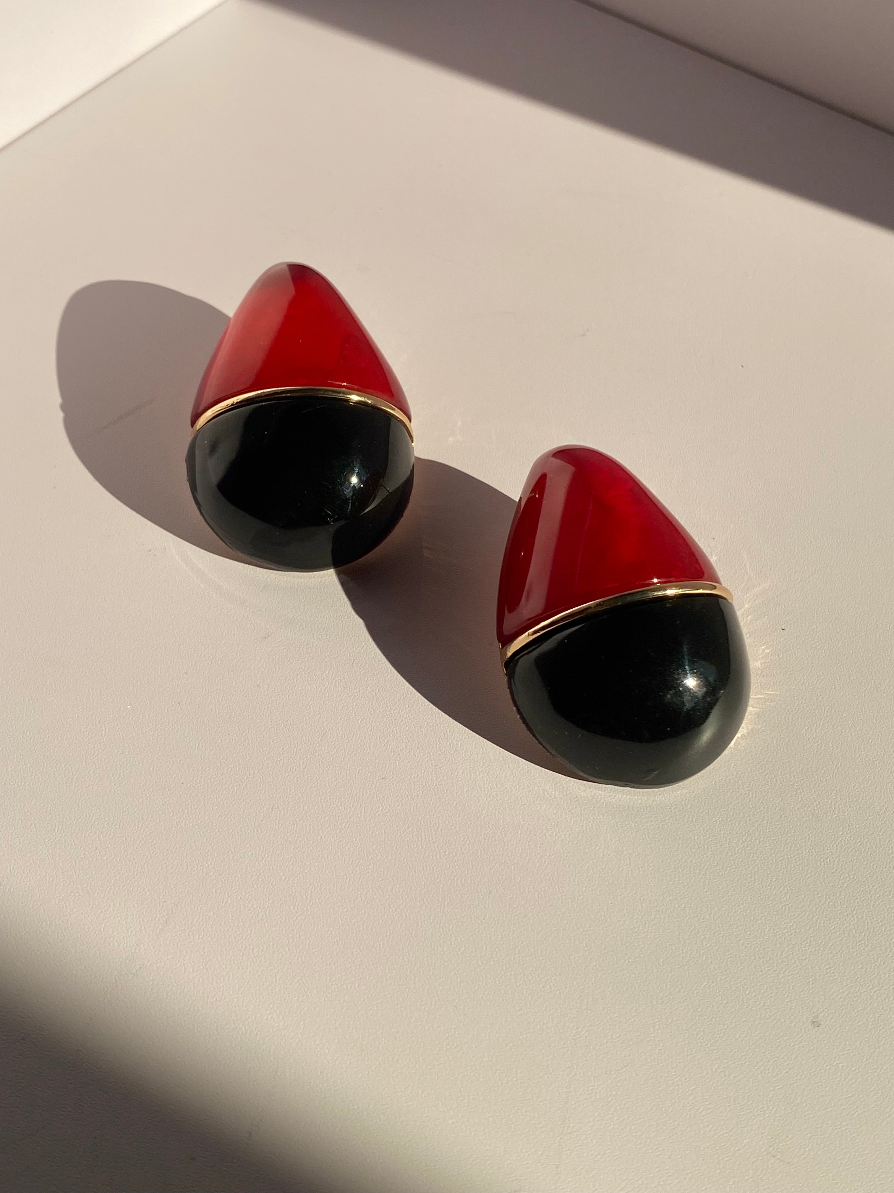 Oversized red and black statement stud earrings with glossy finish and gold-tone accent from LYSAIRE