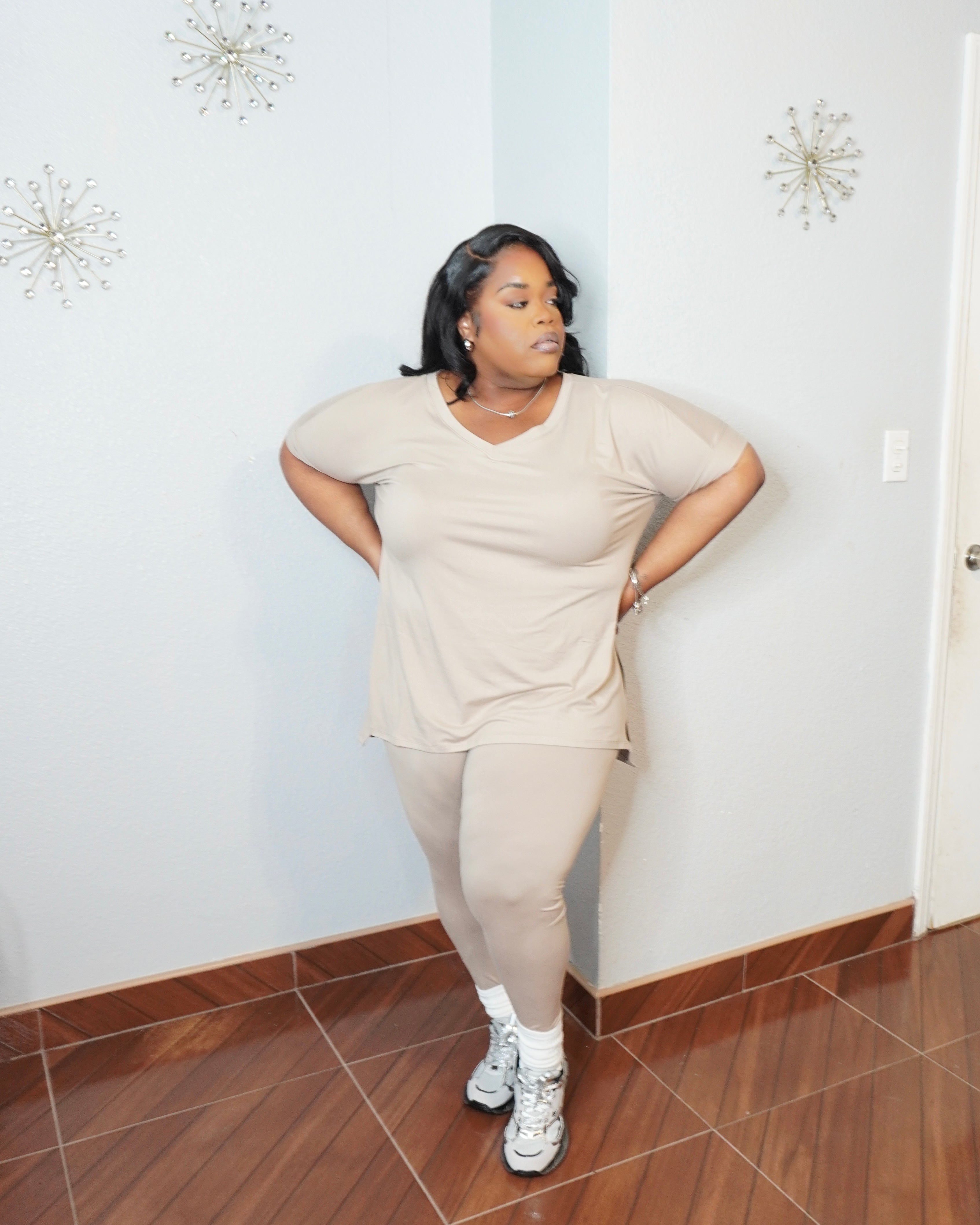 Plus size model wearing legging set styled casually with sneakers