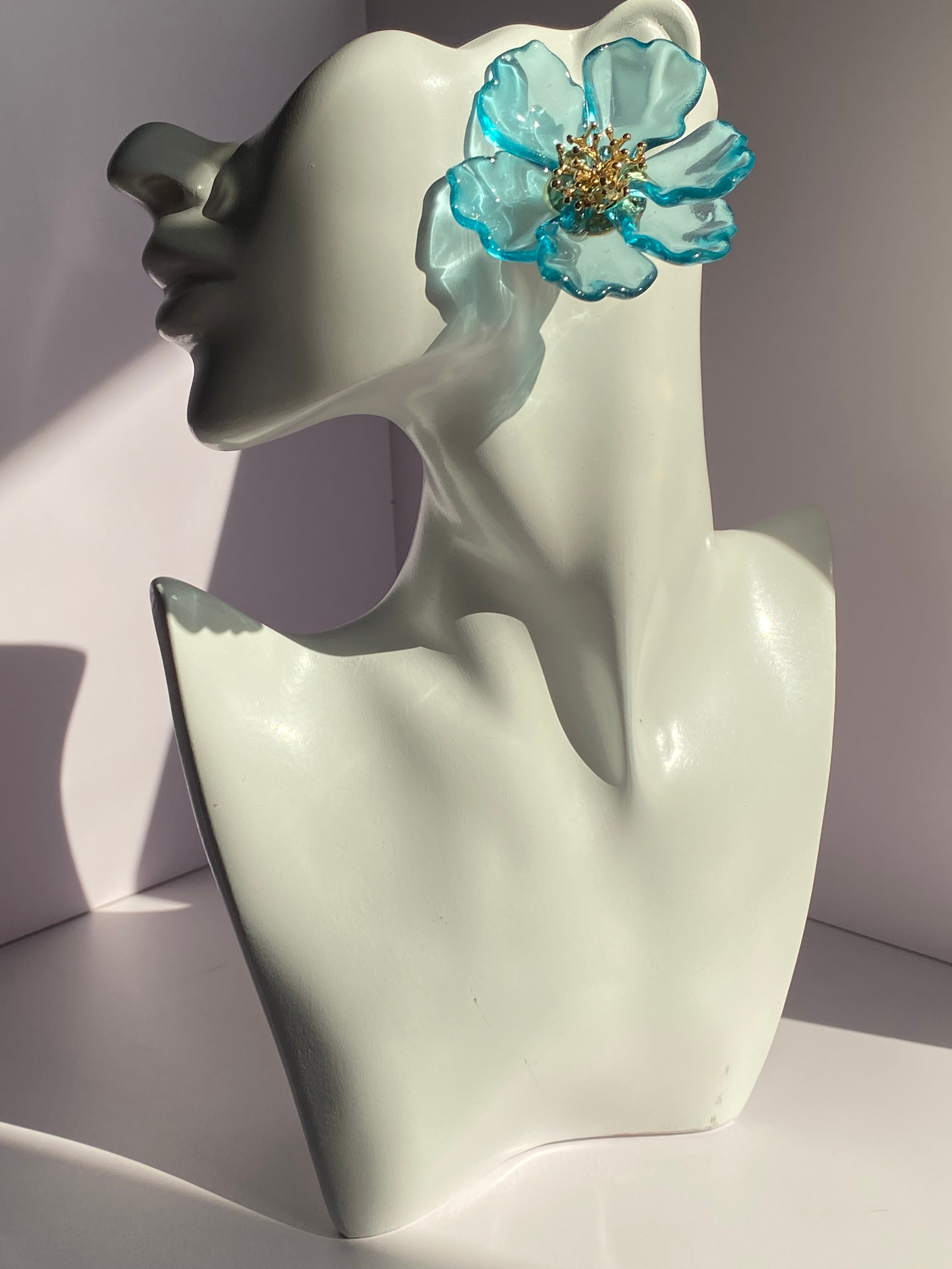 Aqua blue oversized flower earring featuring translucent turquoise-edged petals and gold-tone centerpiece