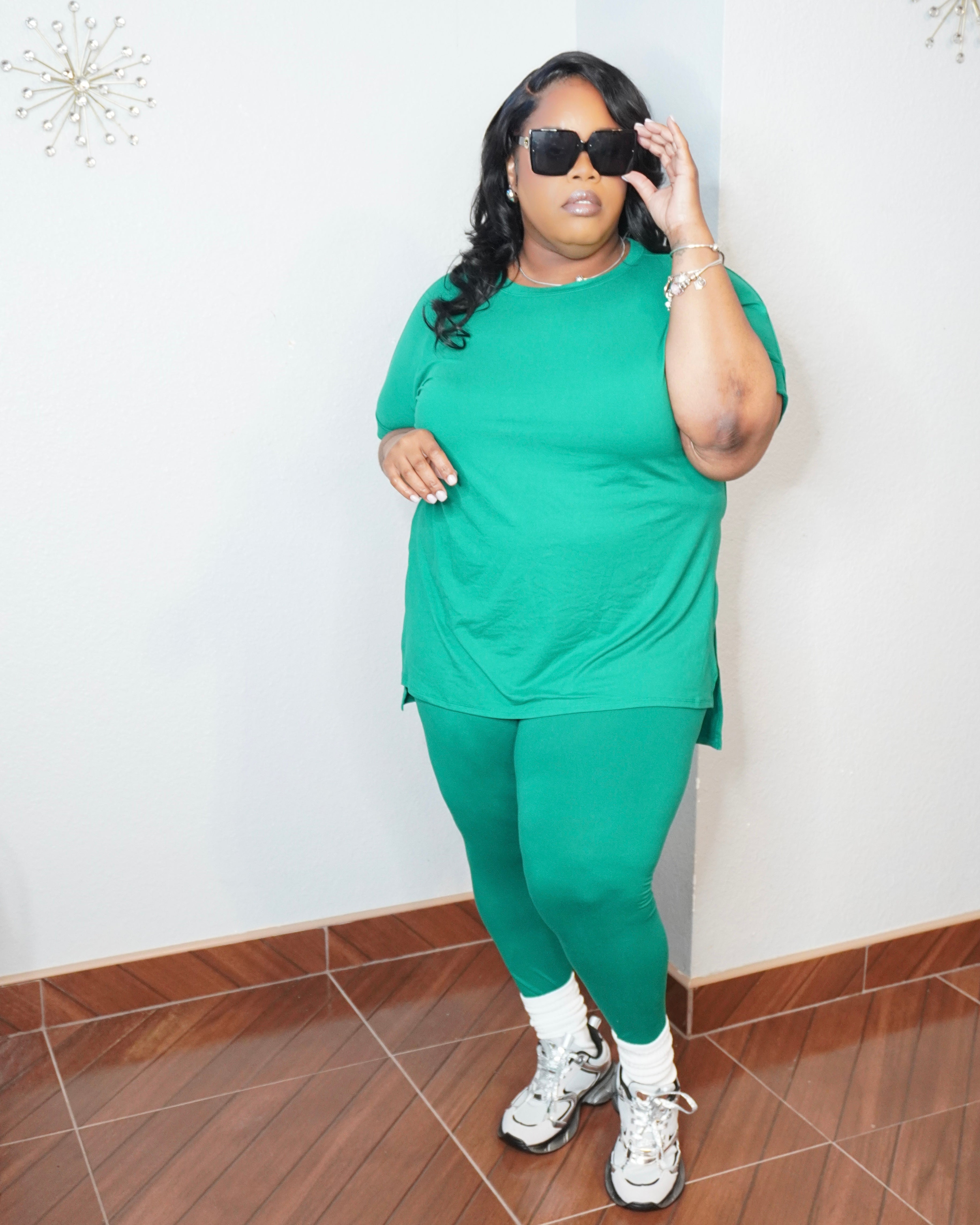 Side angle of plus size green legging set styled with sneakers casual look