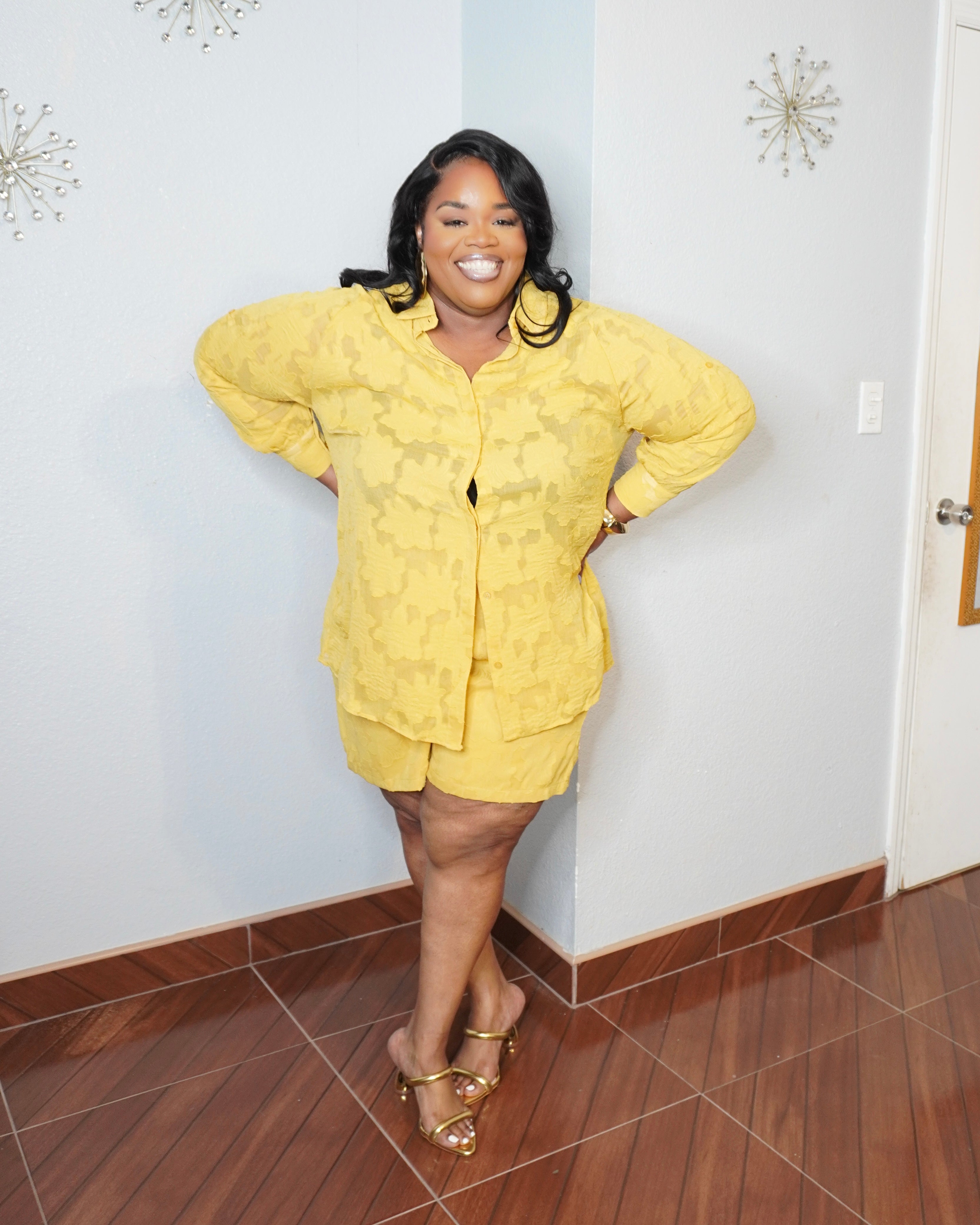 Smiling plus size model in luxury yellow matching set