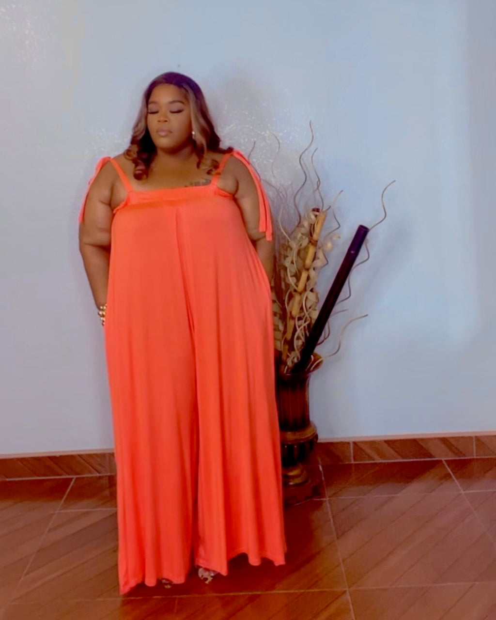 Plus size orange oversized wide leg jumpsuit with stretch fabric pocket view from Lysaire boutique