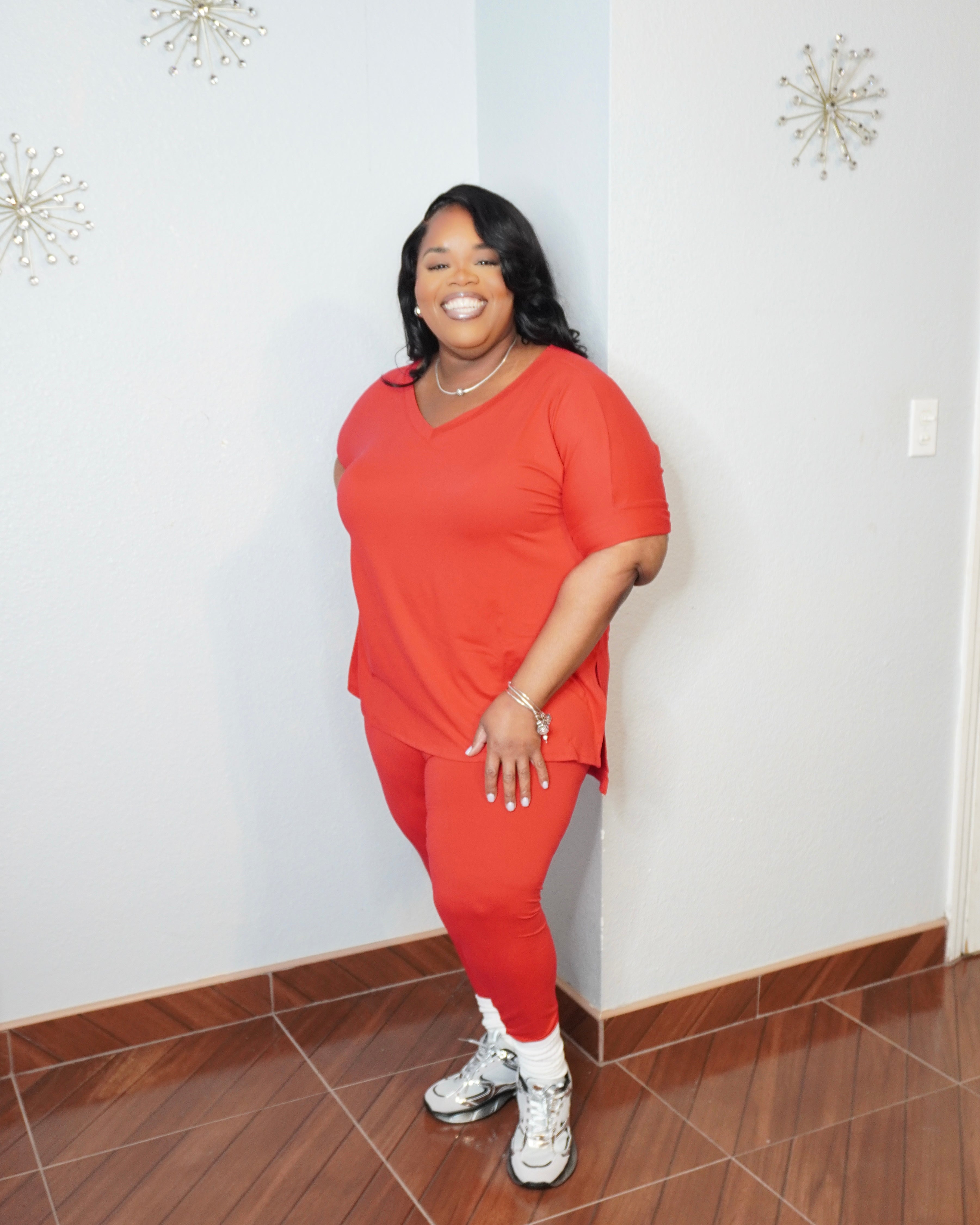 Model posing in plus size legging set showing full length leggings fit