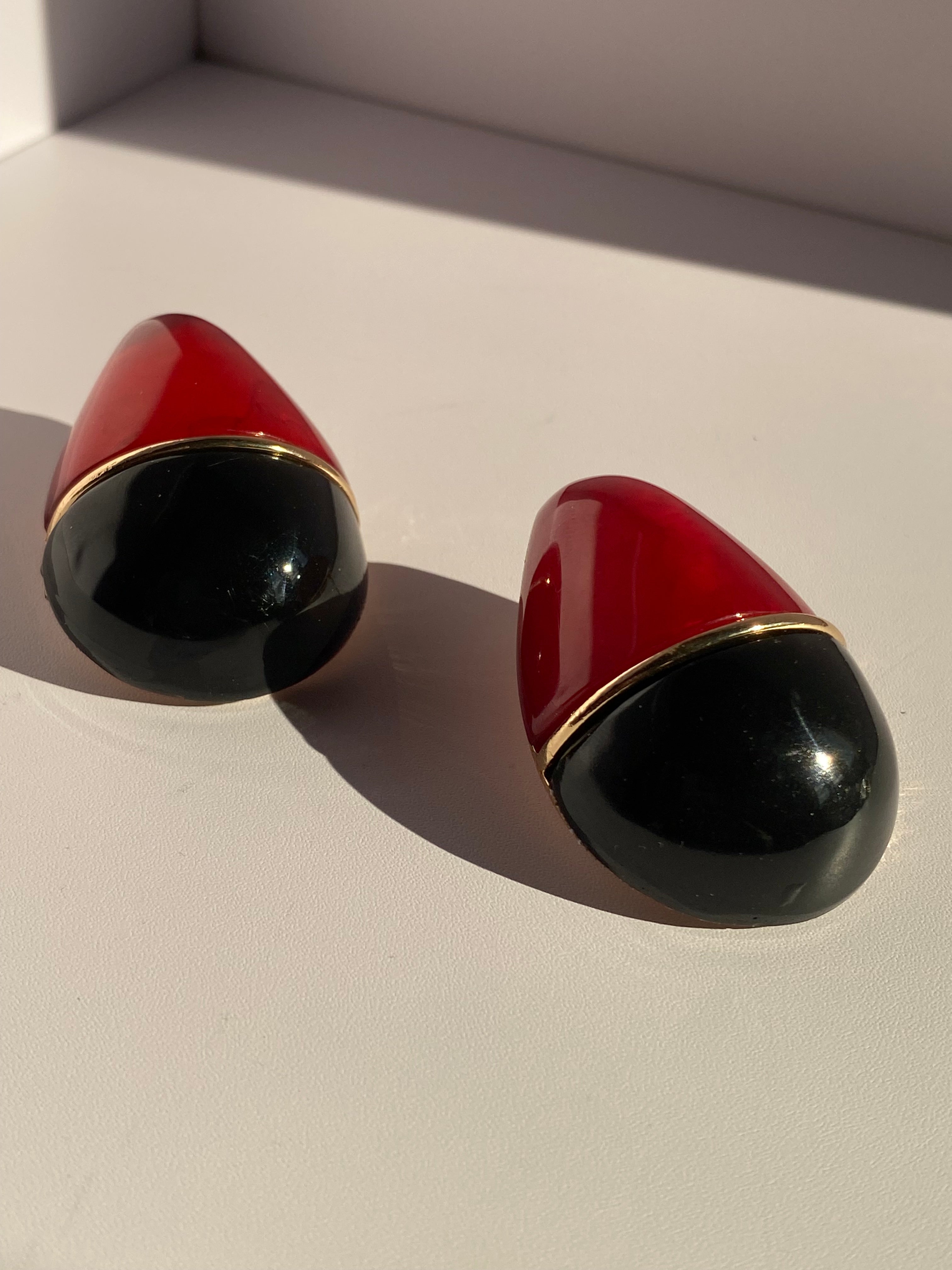 Rouge Noir two-tone red and black sculptural statement earrings with polished gold-tone detailing