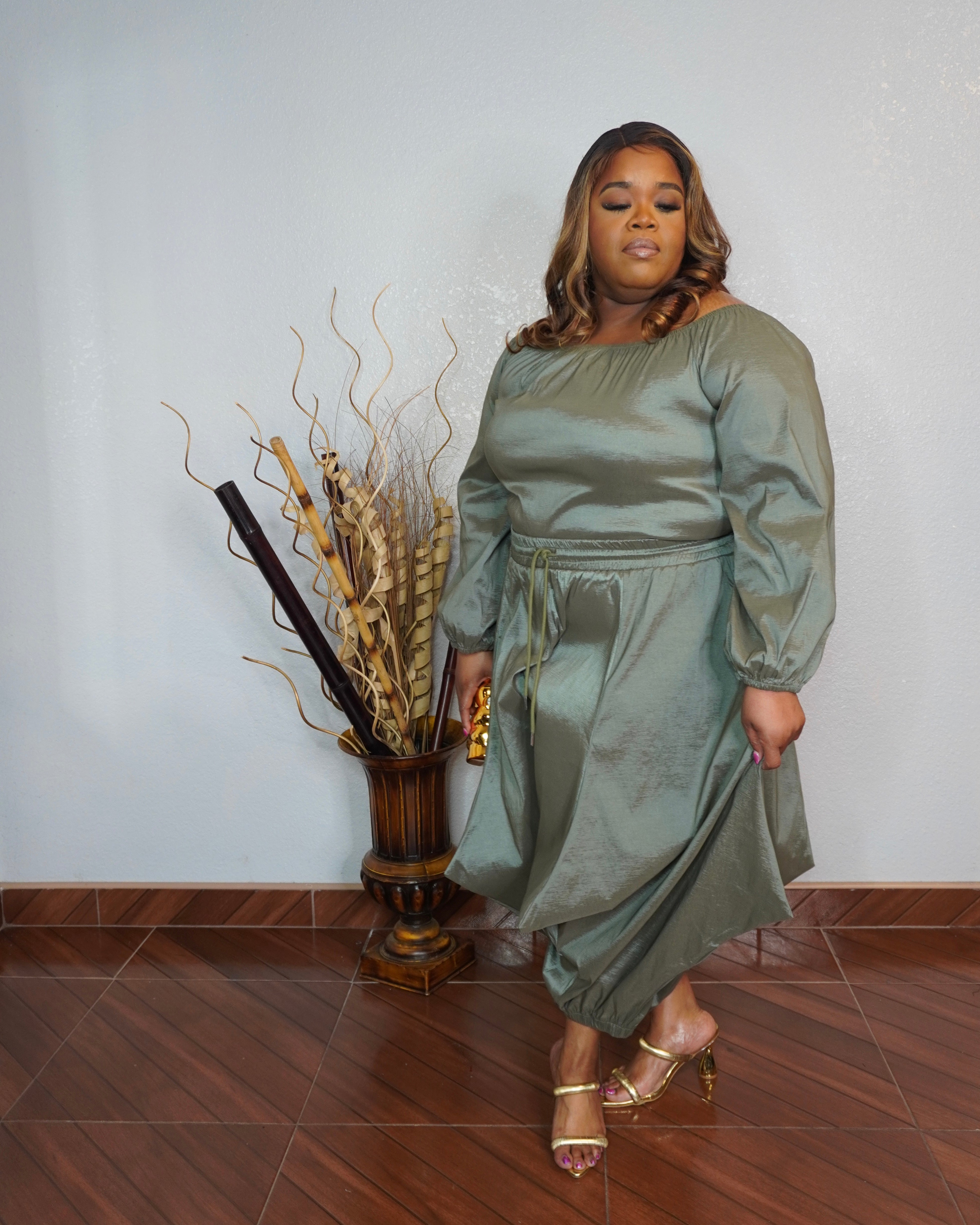 Side view of plus size olive pant set with wide leg pants and relaxed silhouette