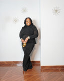 Curvy woman modeling luxury black maxi dress with open back
