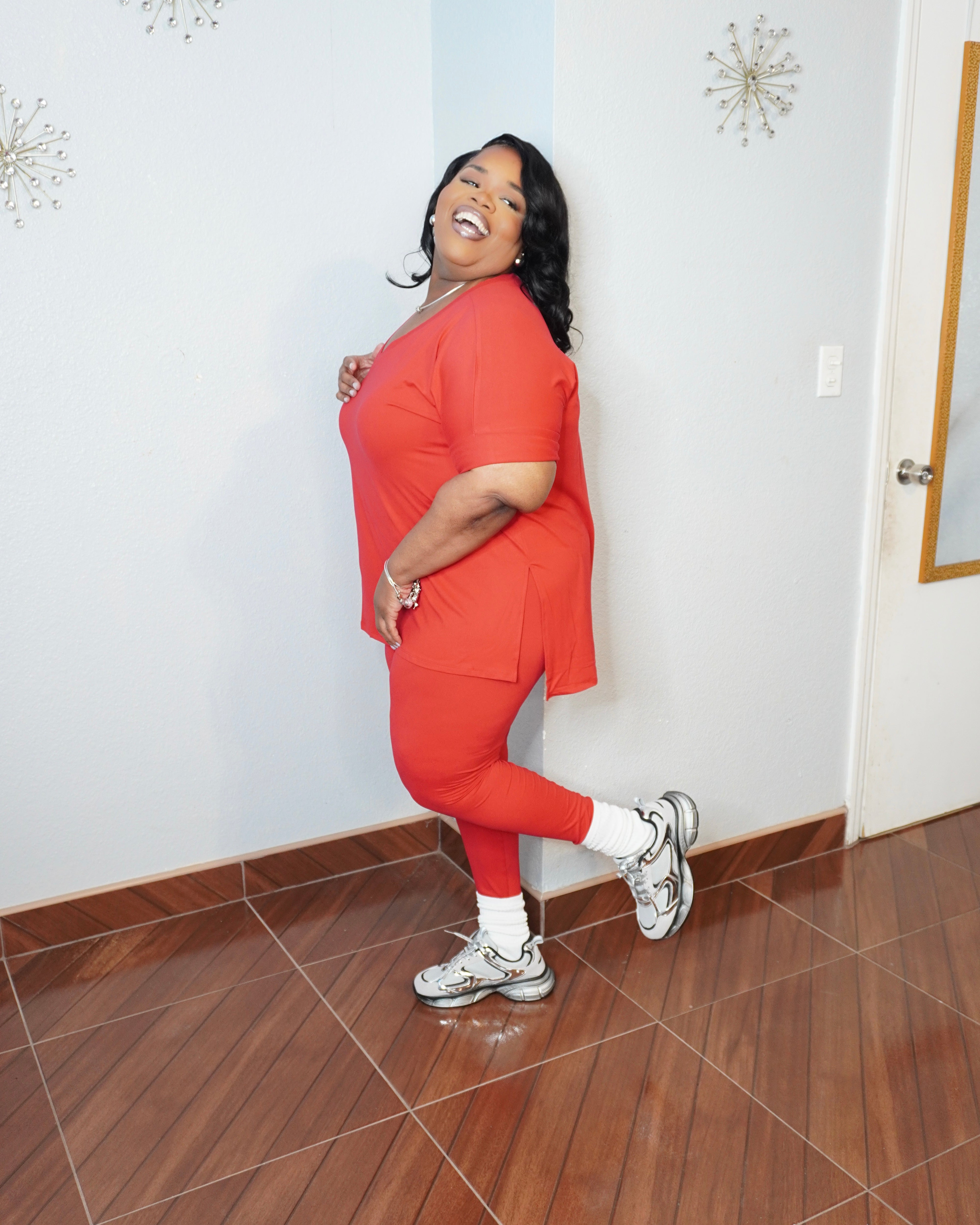 Model posing in plus size legging set showing full length leggings fit