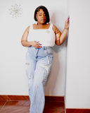 Curvy woman wearing light wash pearl detail jeans