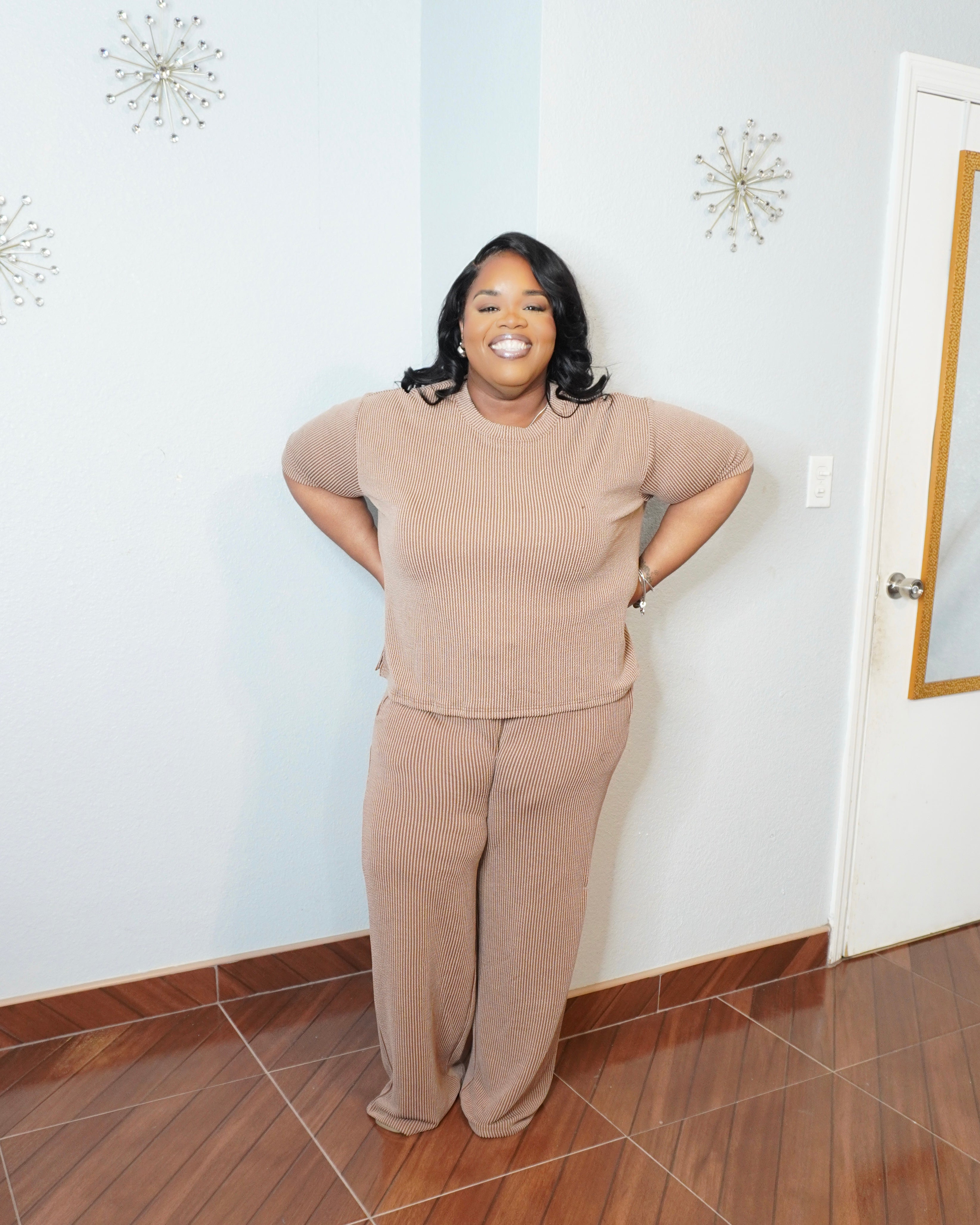 Model posing in plus size ribbed set highlighting comfort and stretch fit