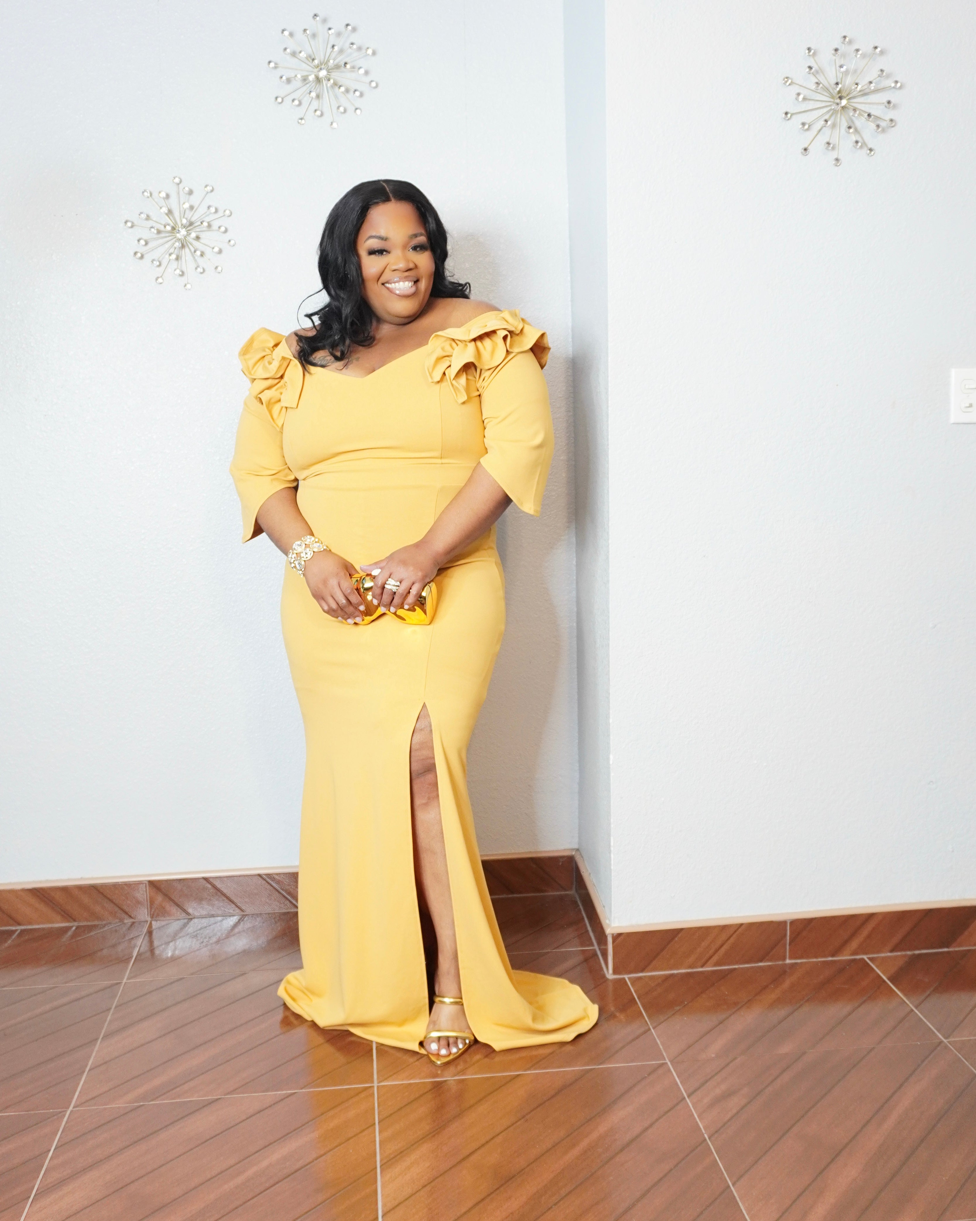 Back view of mustard plus size formal dress with floor-length design