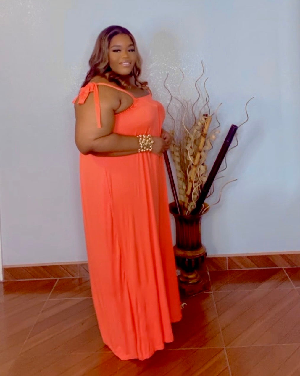 Plus size orange oversized wide leg jumpsuit with stretch fabric side view from Lysaire boutique