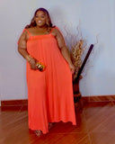 Plus size orange oversized wide leg jumpsuit with stretch fabric front view from Lysaire boutique
