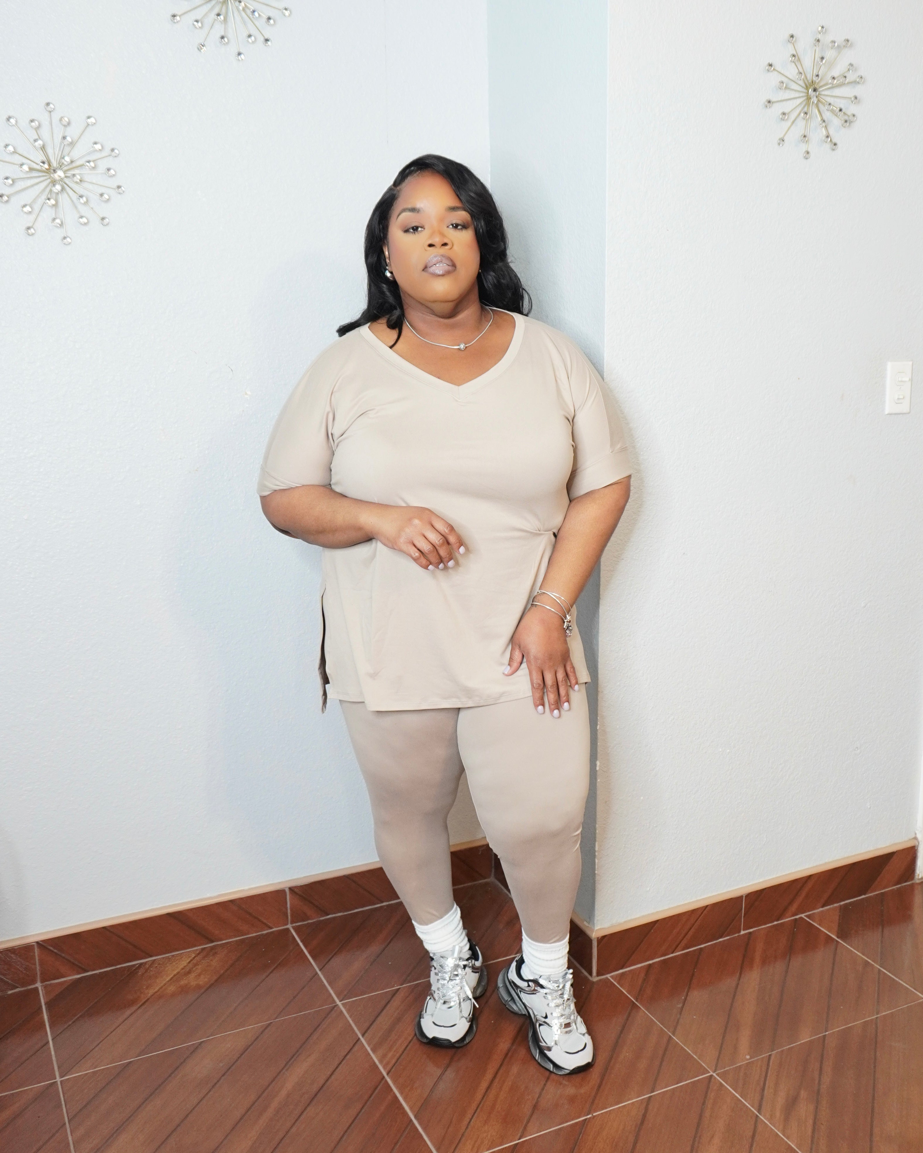 Side pose of plus size two piece set showing curve hugging leggings
